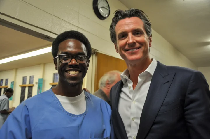Emile DeWeaver with then Lieutenant Governor Gavin Newsom in San Quentin Prison, 2016.